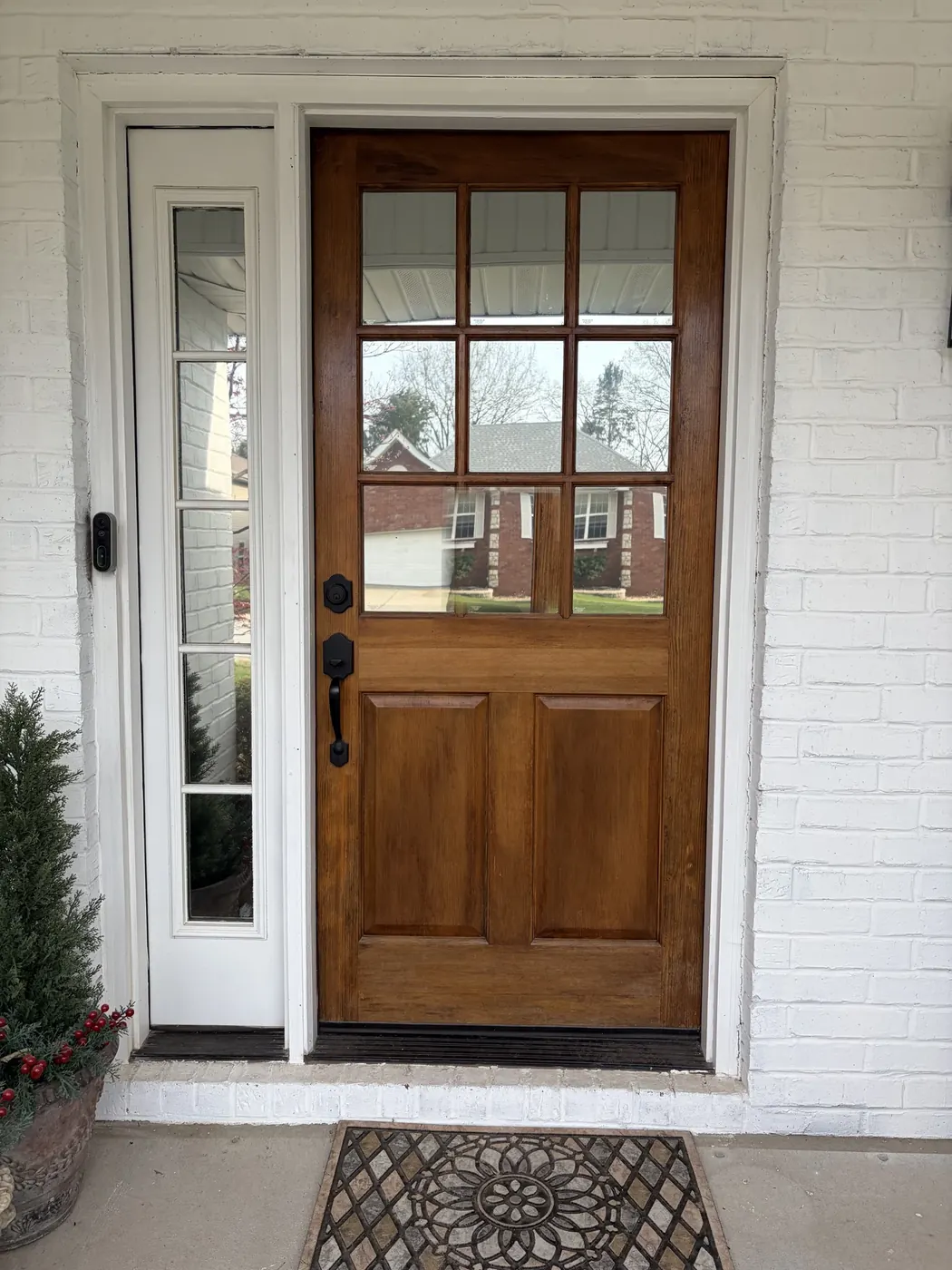 Before: the entry had an older look and visible glass reflections.
